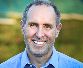 Smiling male oral cancer screening patient in Seattle looks into the camera