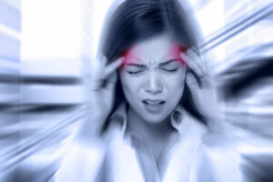 A young woman experiencing headaches from bruxism and stress.
